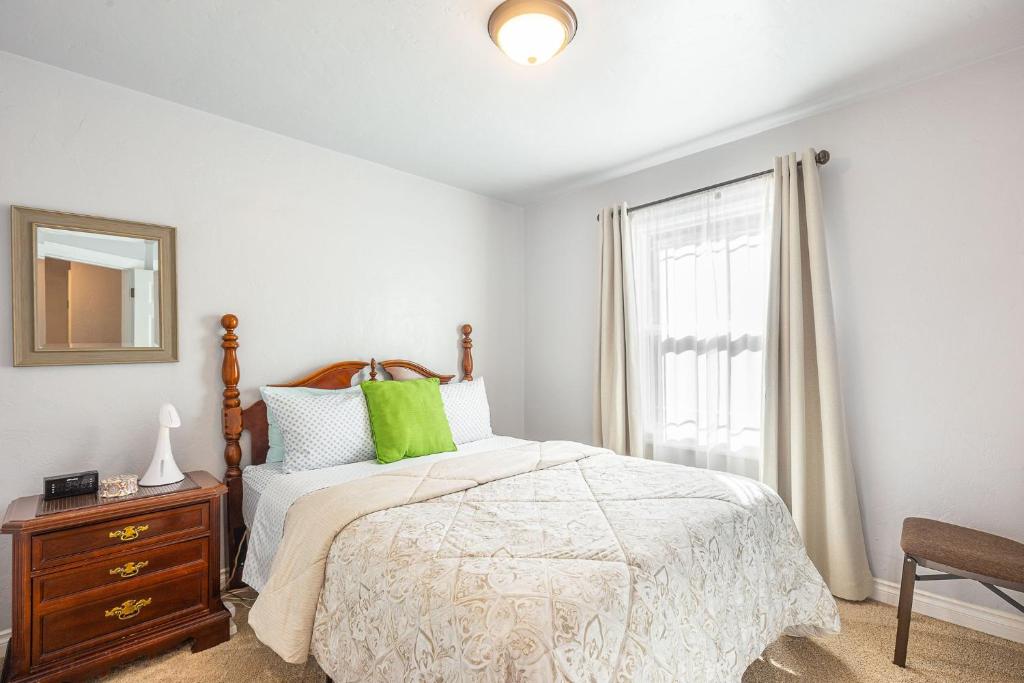 a bedroom with a bed and a dresser and a window at Duplex in Alberta Art District in Portland