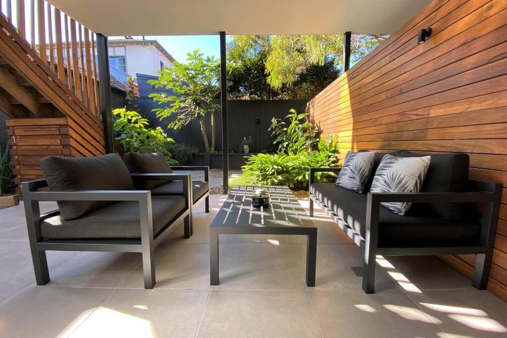 a patio with two chairs and a table at The Mitchell Bondi Garden 4 in Sydney