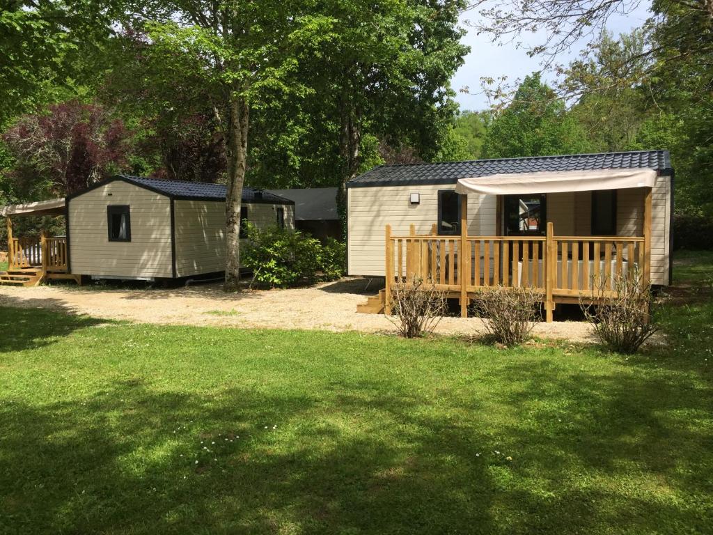 a cabin with a porch and a deck at Camping de la Bonnette in Caylus