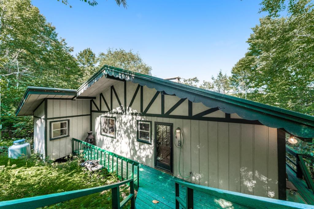 a small house with a green fence around it at Dogwood Branch in Beech Mountain
