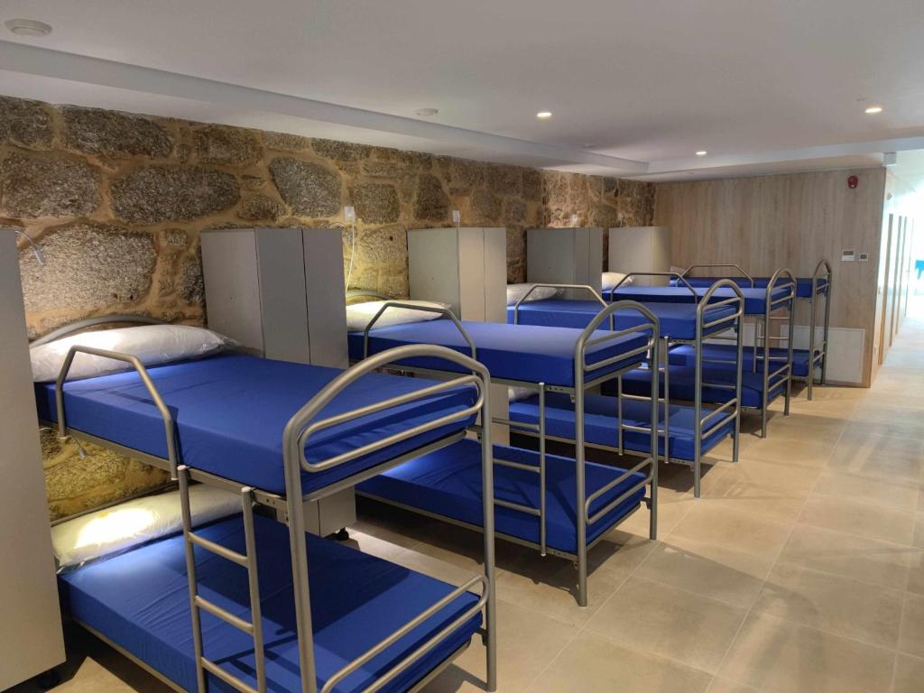 a row of bunk beds in a room at A Pousa do Asma in Chantada