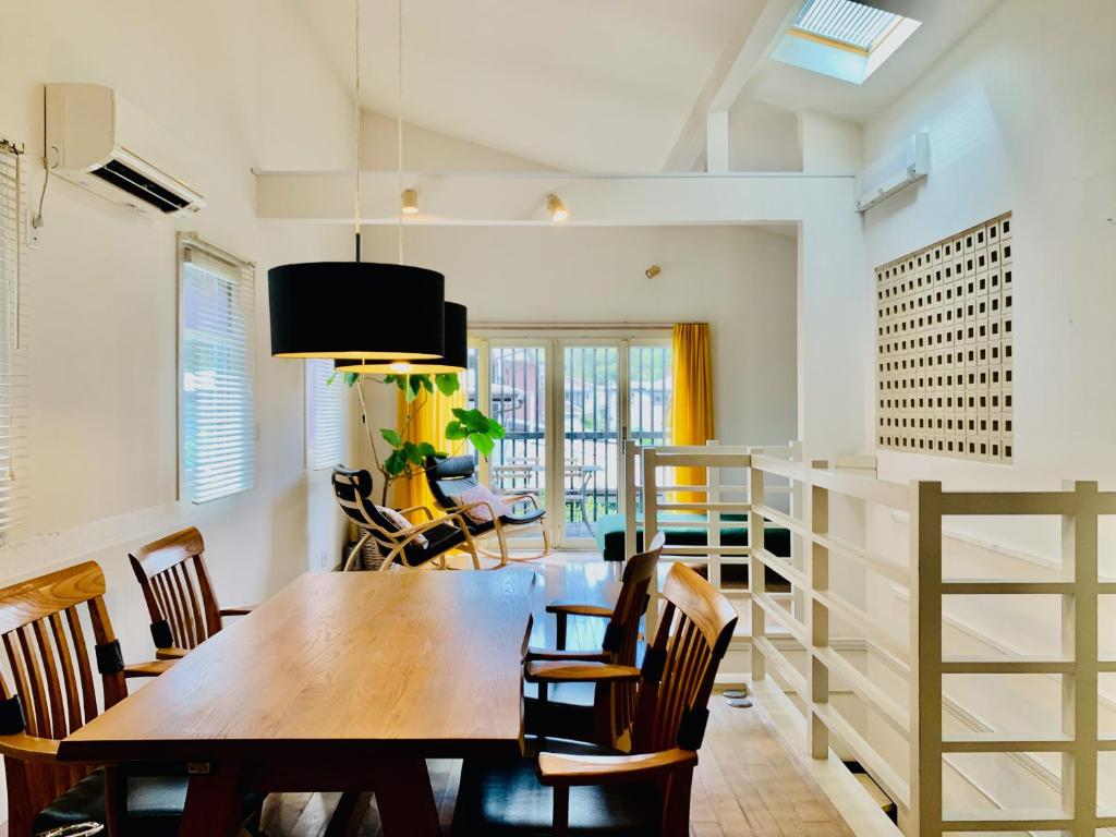 a dining room with a wooden table and chairs at Kamakura Vacation House in Kamakura