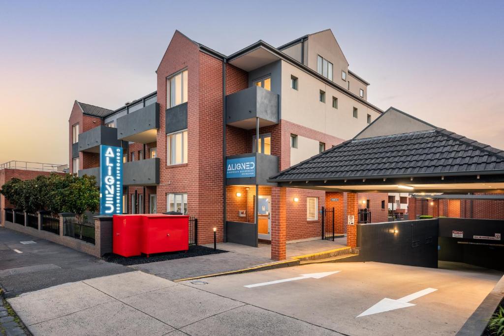 a building with a parking lot in front of it at Aligned Corporate Residences Kew in Melbourne