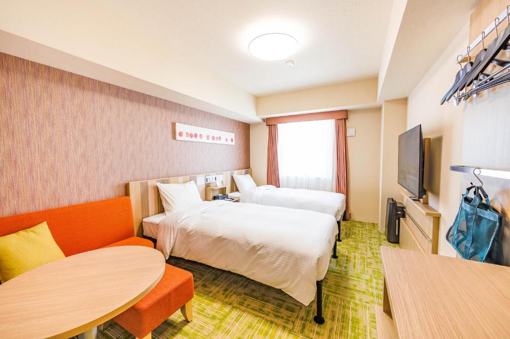 Postel nebo postele na pokoji v ubytování Tabino Hotel lit Matsumoto Milky white Onsen