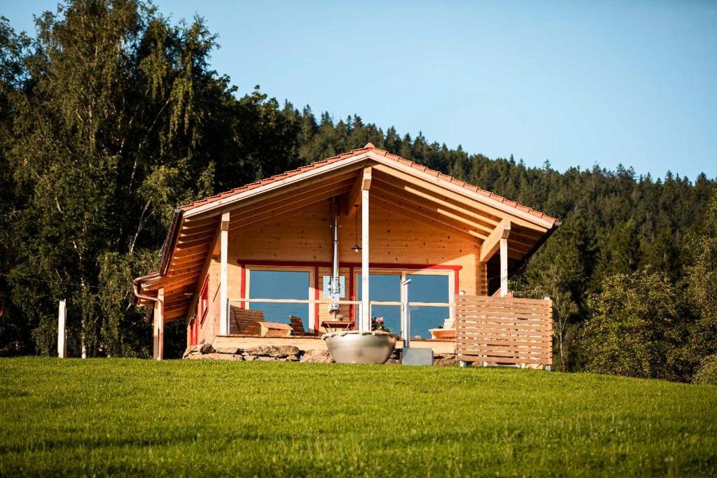 a small log cabin with a view of the ocean at Himmelreich-Chalets in Lam