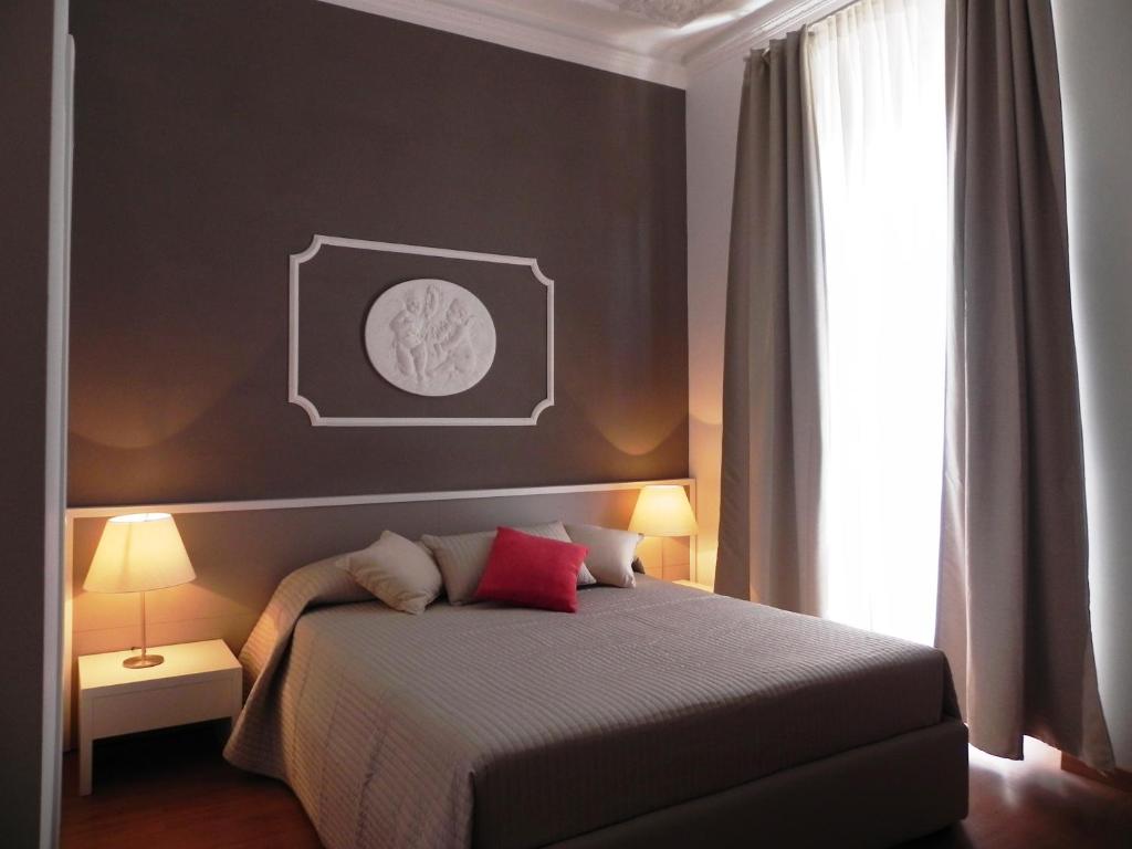 een slaapkamer met een bed met een zwarte muur bij Palazzo Gropallo Rooms in Genua