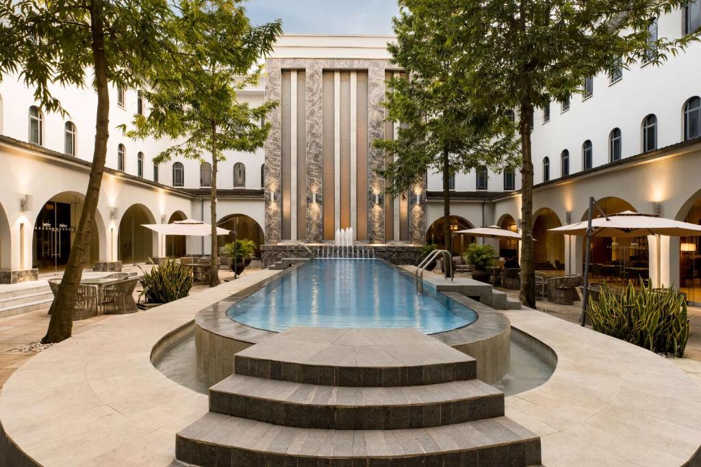 a pool in the courtyard of a building at Radisson Lagos Ikeja in Lagos