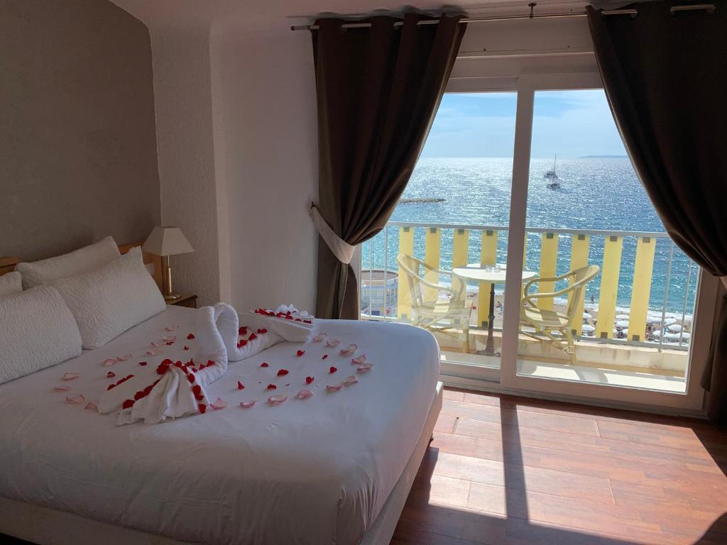 - une chambre avec un lit et une vue sur l'océan dans l'établissement Le Beau Séjour, à Saint-Raphaël