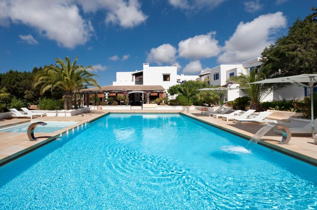 a swimming pool in front of a villa at Paraíso de los Pinos in Sant Francesc Xavier