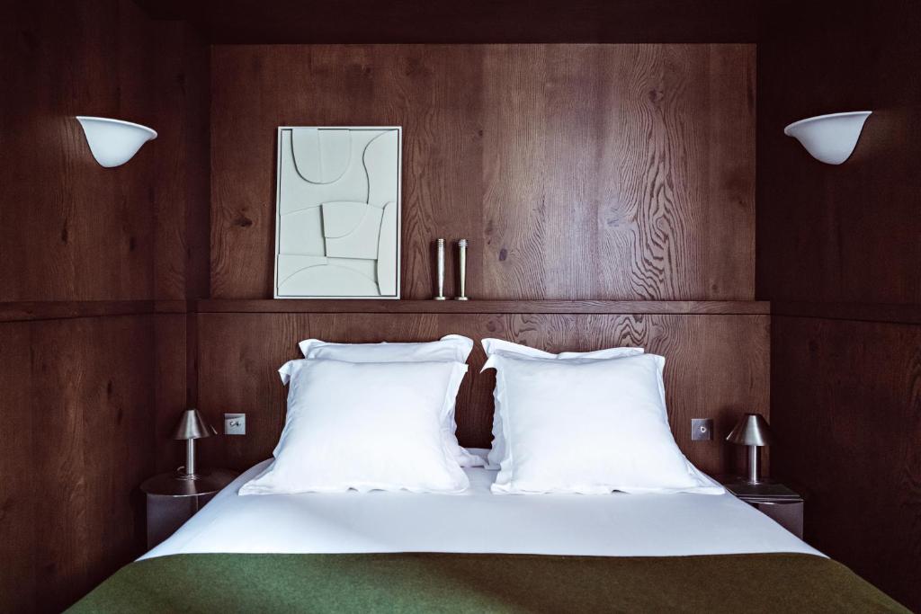 a bedroom with a bed with two white pillows at Hotel des Académies et des Arts in Paris