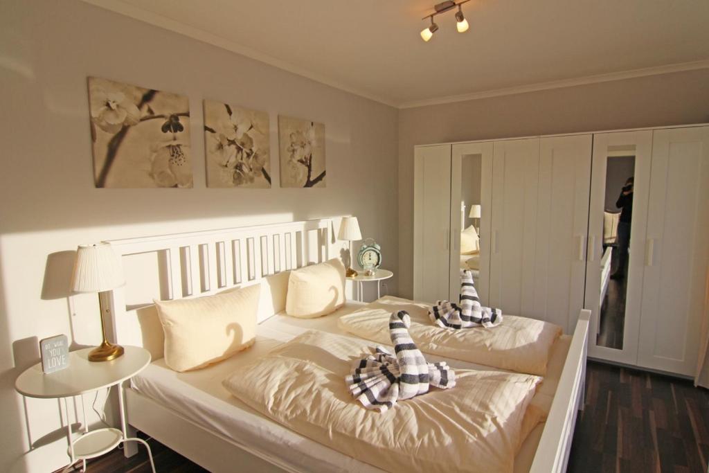 a bedroom with two beds with blankets and pillows at Nina in Wenningstedt