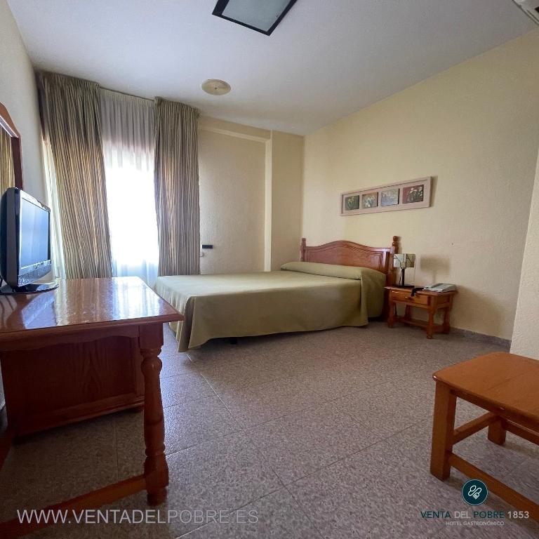 Łóżko lub łóżka w pokoju w obiekcie Hotel Venta del Pobre