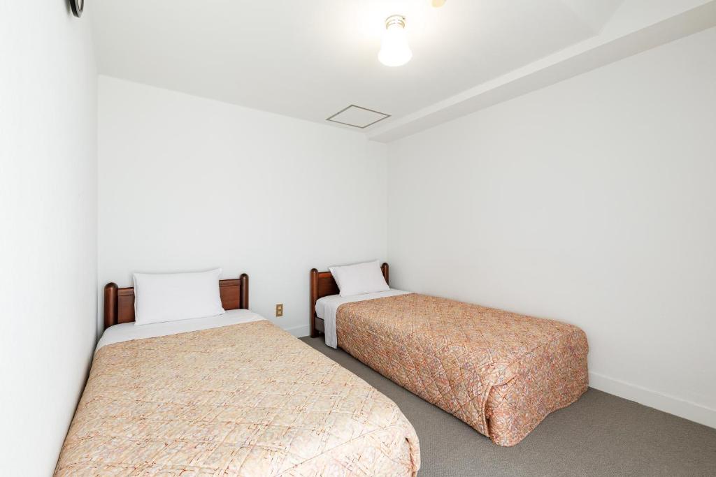 Postel nebo postele na pokoji v ubytování Hotel WWJ