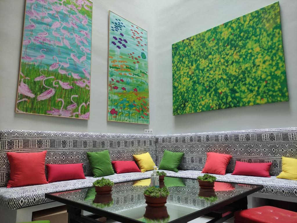 a living room filled with lots of colorful furniture at New Samay Hostel in Seville