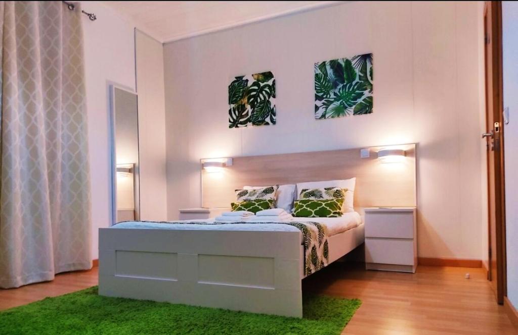 a bedroom with a bed and a green rug at 3 bedrooms house with furnished terrace and wifi at Ponta Delgada in Ponta Delgada