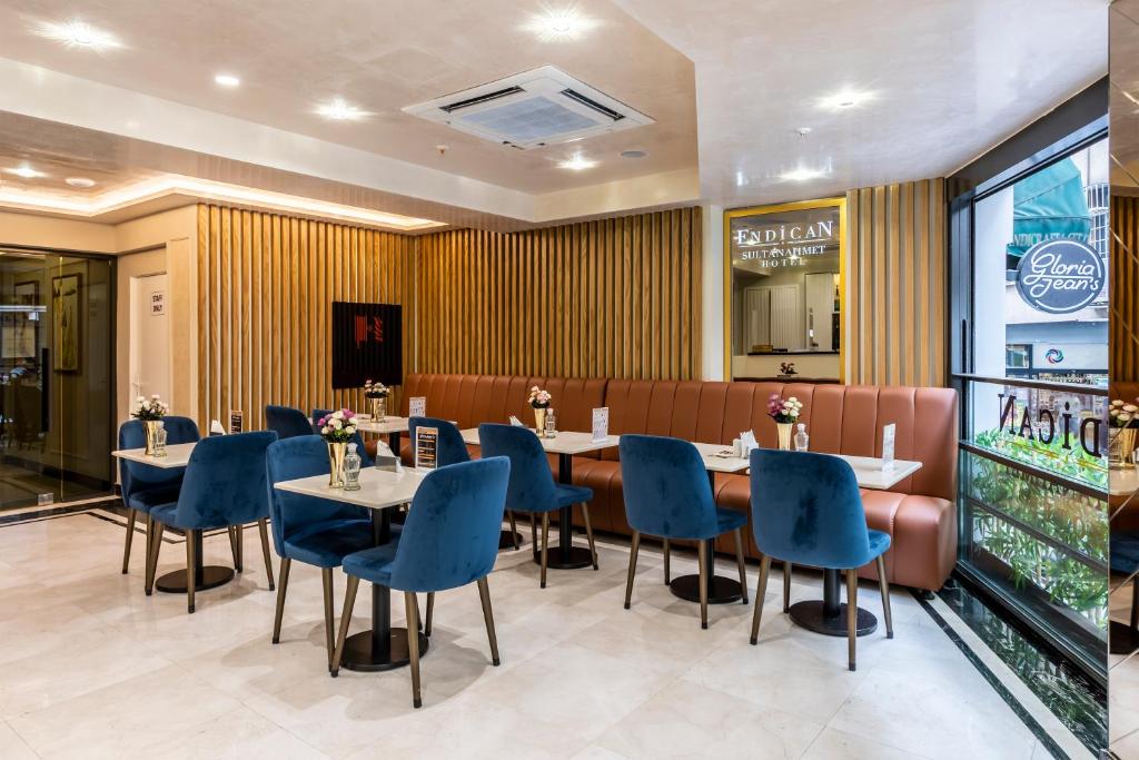 a dining room with tables and blue chairs at Endican Sultanahmet Hotel in Istanbul