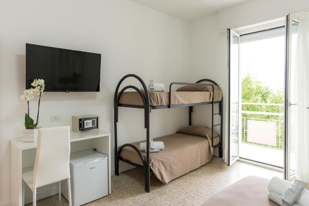 Postel nebo postele na pokoji v ubytování Hotel Ninfea Cattolica