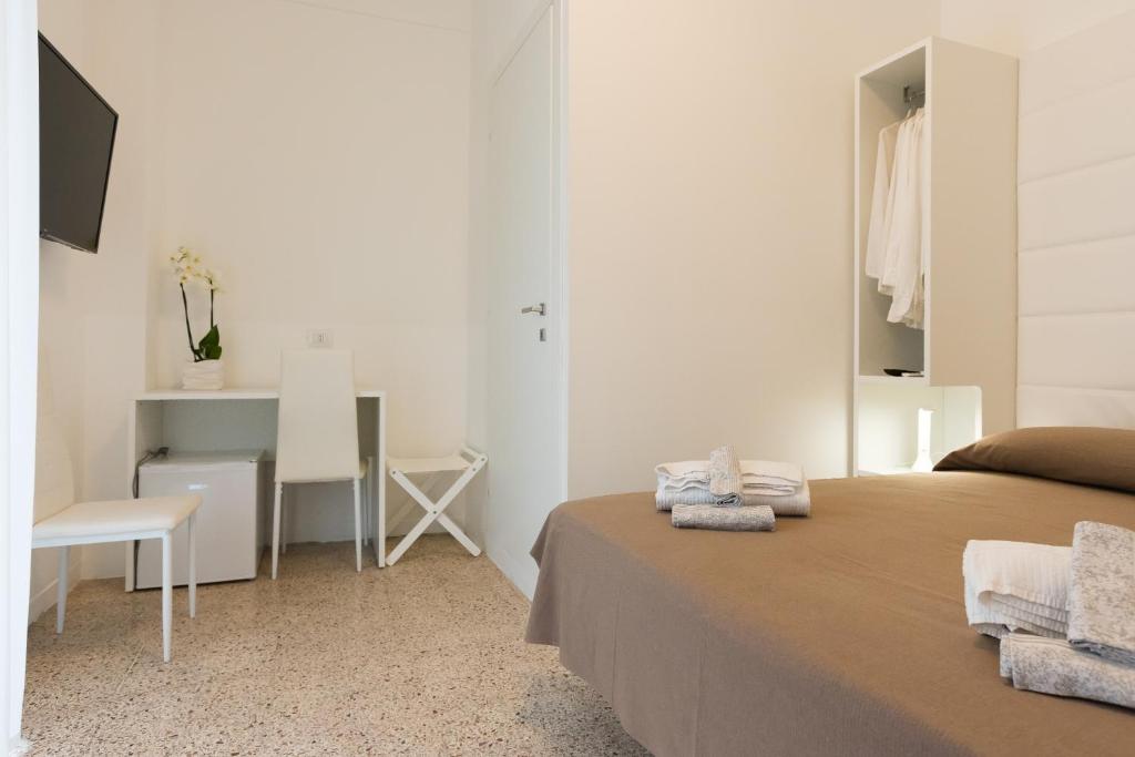 Postel nebo postele na pokoji v ubytování Hotel Ninfea Cattolica