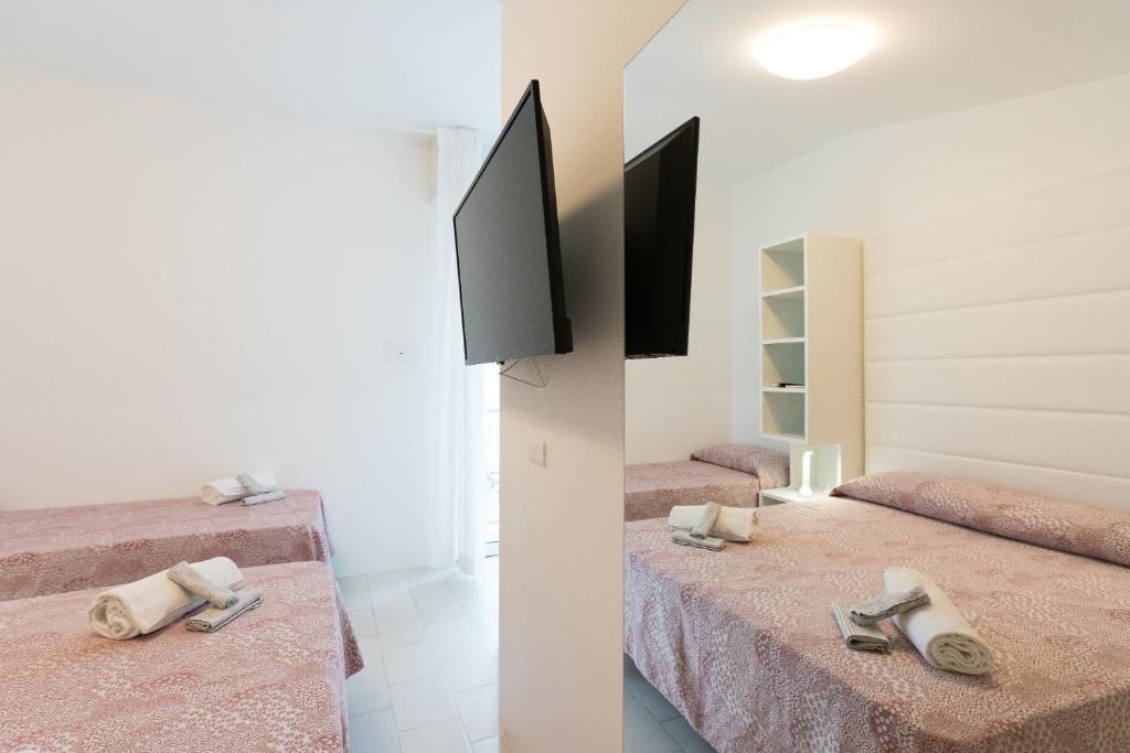 Postel nebo postele na pokoji v ubytování Hotel Ninfea Cattolica