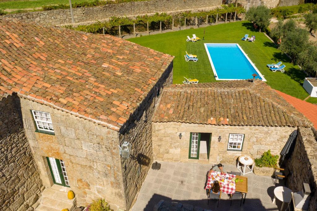 an aerial view of a house with a swimming pool at Casa da Cerca in Sortelha