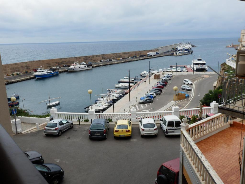 a bunch of cars parked in a parking lot near the water at Vistas al mar y cerca de la playa in L'Ametlla de Mar