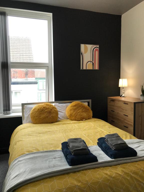 a bedroom with a bed with two towels on it at CLIFTON Apartments in Liverpool