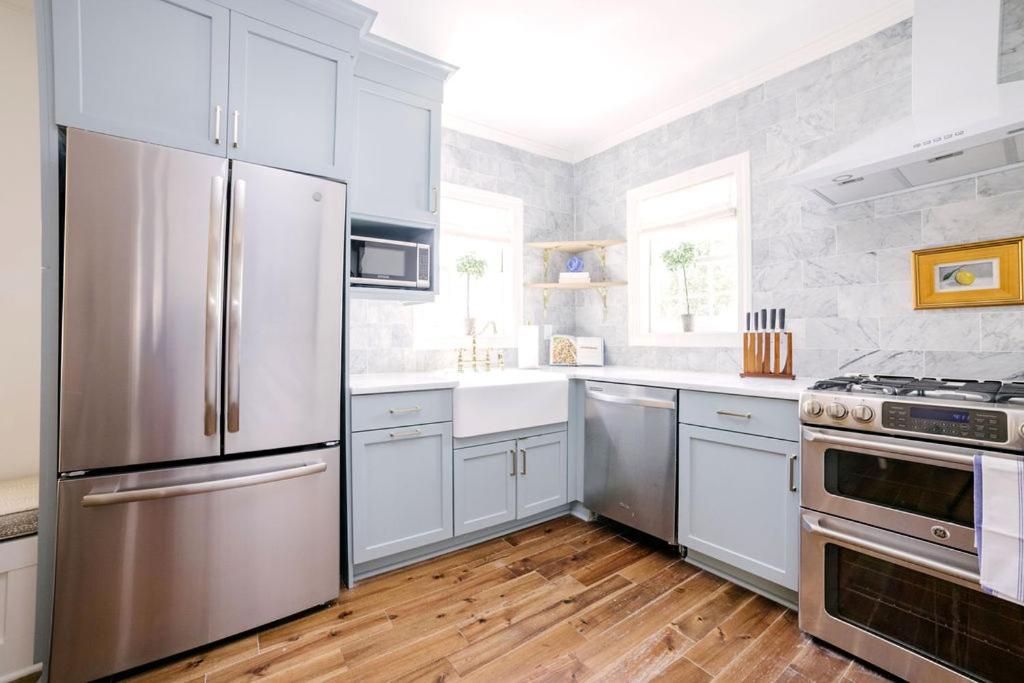 a kitchen with white cabinets and stainless steel appliances at Guesthouse Charleston EAST 42 B in Charleston