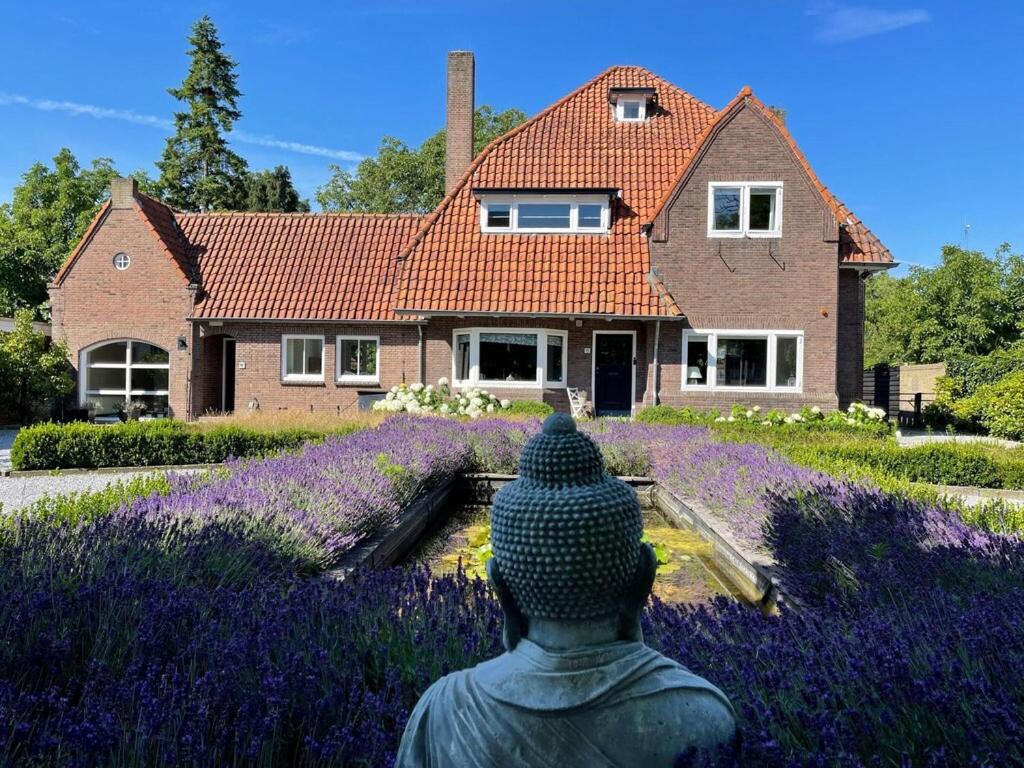 een beeld in een veld van lavendel voor een huis bij Luxury Villa in Helmond with a Private Pool in Helmond