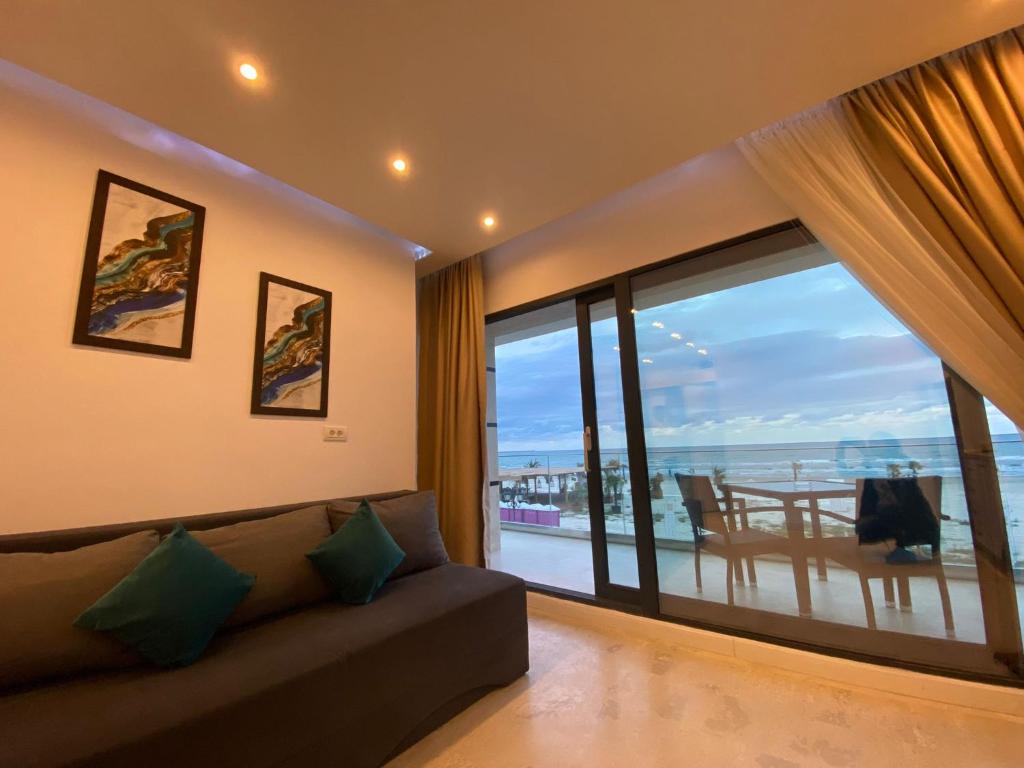 a living room with a couch and a view of the ocean at Apartament Ella front view in Mamaia Nord