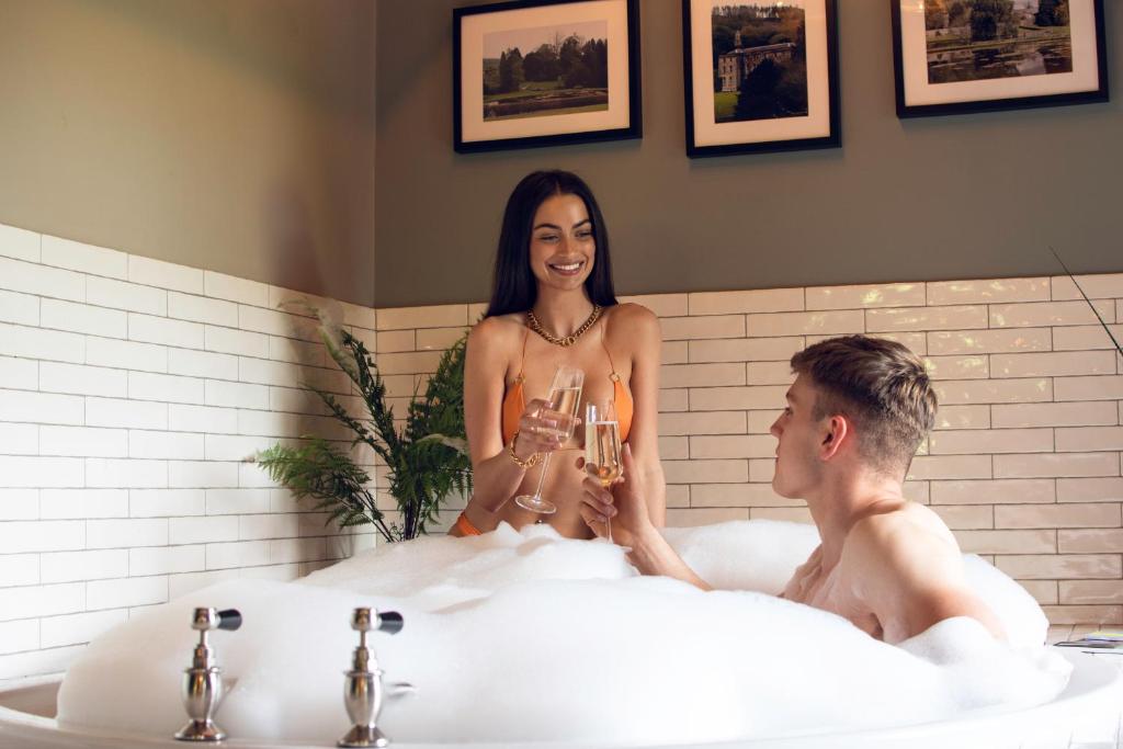 a man and a woman sitting in a bath tub at Marske Stables in Marske