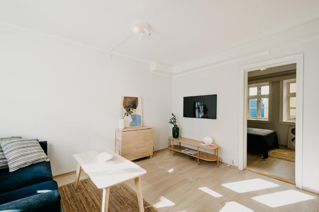 a living room with a couch and a table at Bergen Beds in Bergen
