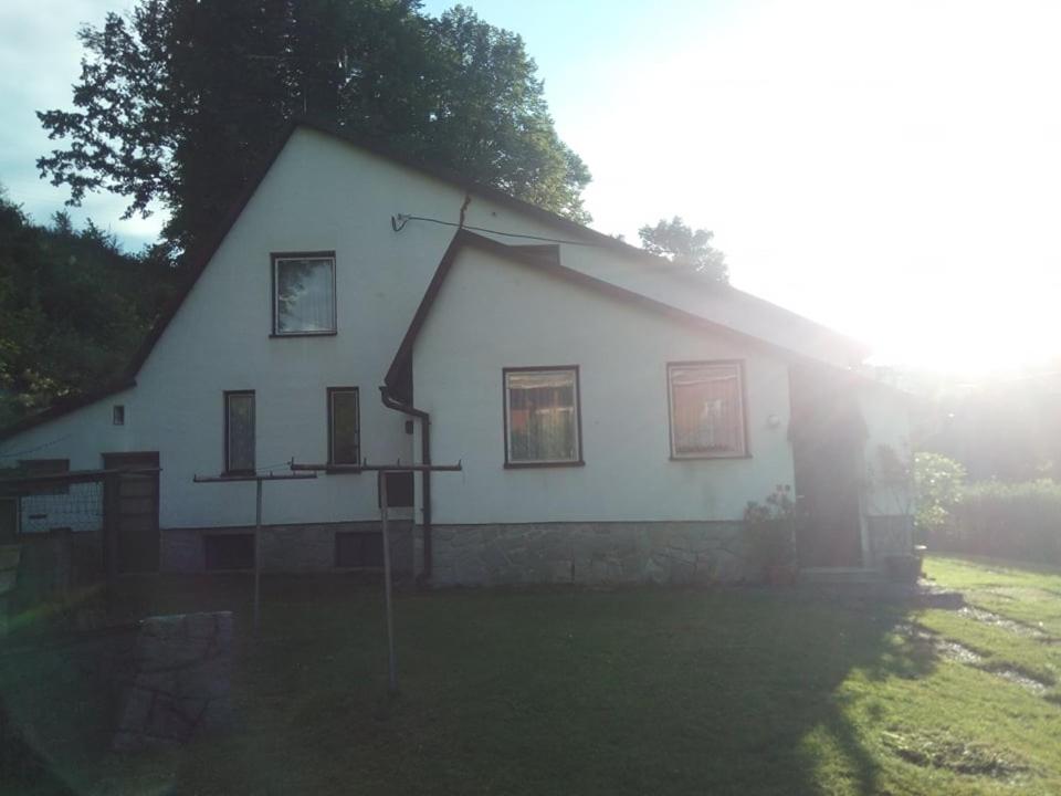 a large white house with windows on a field at Chalupa V Mlýnkách in Bělá pod Pradědem