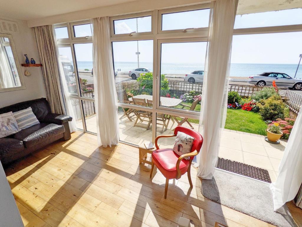 a living room with a view of the ocean at Stonesthrow - Bognor Regis in Bognor Regis