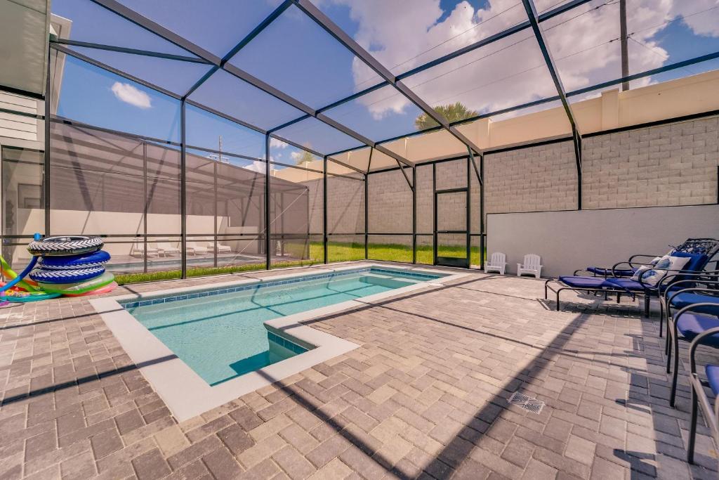 an indoor swimming pool with a large glass ceiling at Windsor Island Resort 5 Bedroom Townhome Private Pool Disney in Davenport