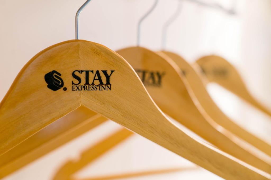 a row of wooden benches with the words stay entrepreneurship hanging at Stay Express Inn Chattanooga in Chattanooga