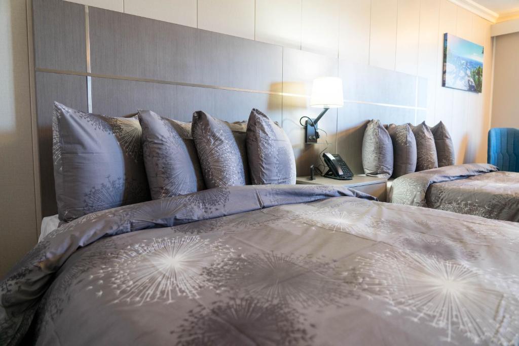 a bedroom with a bed with pillows on it at Stay Express Inn Chattanooga in Chattanooga