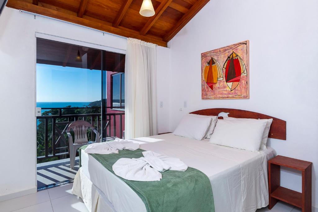 Cama ou camas em um quarto em Pousada Solar das Tartarugas