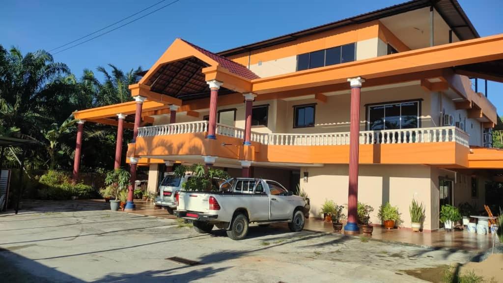 a truck parked in front of a house at Myoldhouse in Lahad Datu