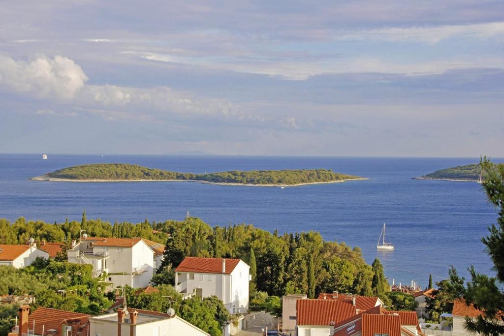 a view of a town and the ocean with a boat at Anna in Hvar * Mittel-Dalmatien in Hvar
