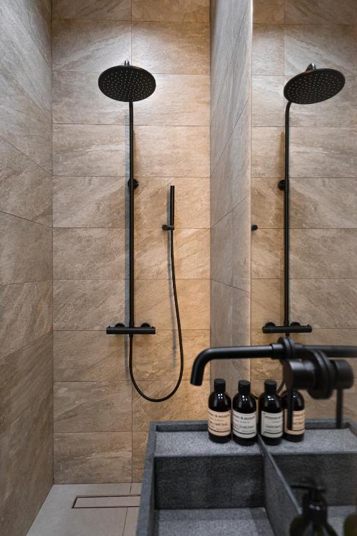 a bathroom with a shower and a sink at Suite Hotel in Kemerovo