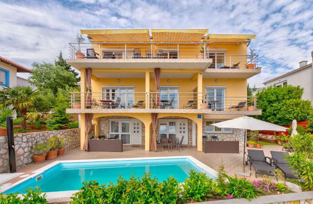 a house with a swimming pool in front of it at One-Bedroom Apartment Crikvenica near Sea 2 in Dramalj