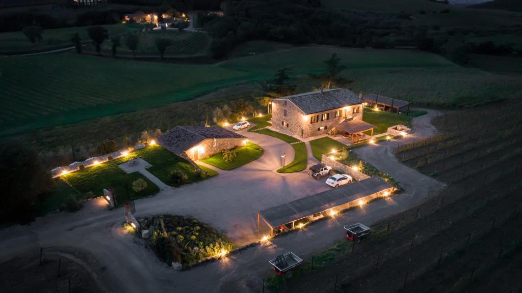 - une vue aérienne de nuit sur une maison éclairée dans l'établissement Wine Estate Rooms Paradiso di Cacuci, à Montalcino