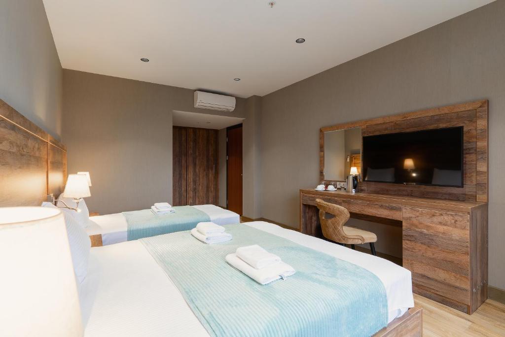 Postel nebo postele na pokoji v ubytování Cozy Loft Hotel