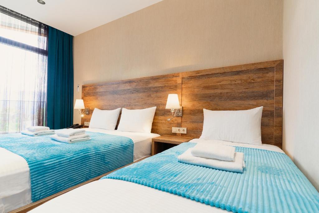 Postel nebo postele na pokoji v ubytování Cozy Loft Hotel