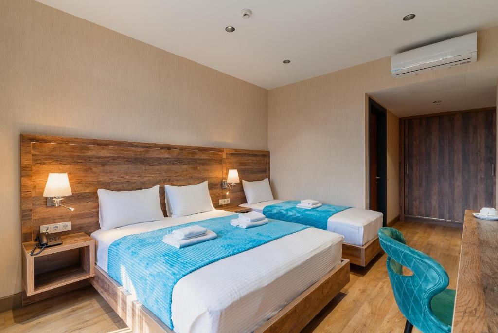 Postel nebo postele na pokoji v ubytování Cozy Loft Hotel