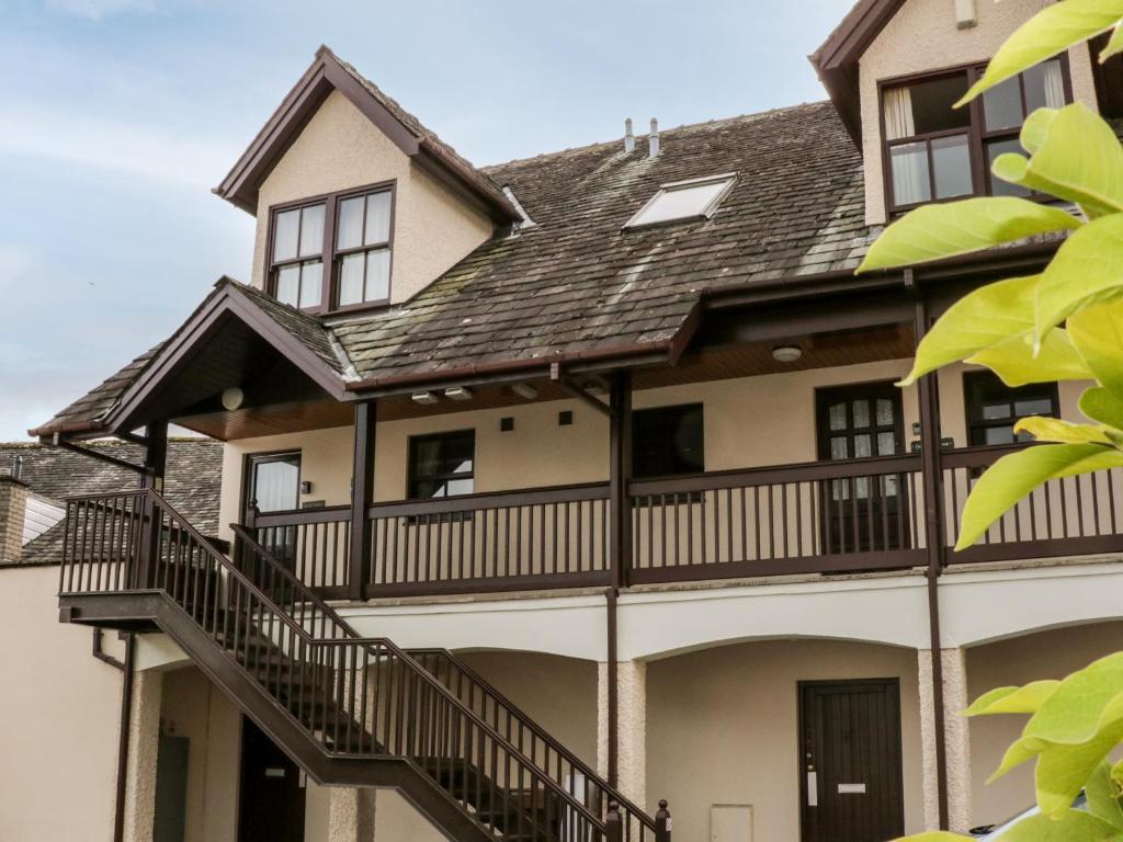 an exterior view of a house with a balcony at Derwent Haven in Keswick