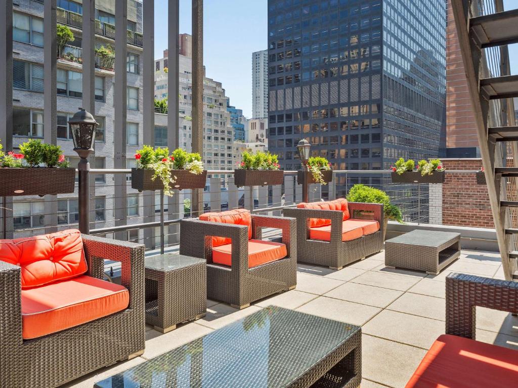 a balcony with chairs and tables on a building at The Historic Blue Angel Hotel Lexington Ave, Ascend Hotel Collection in New York
