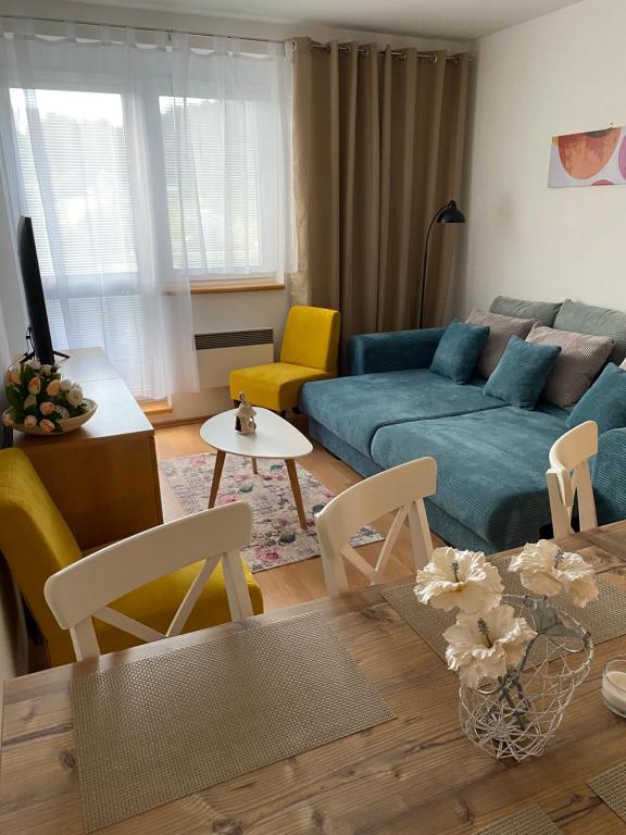 a living room with a couch and a table at Apartment Dony in Donovaly