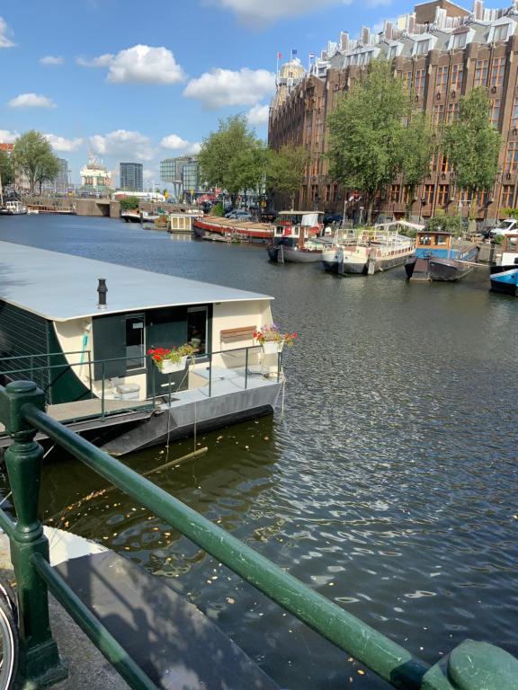 a boat in a river with a house on it at Boat no Breakfast in Amsterdam