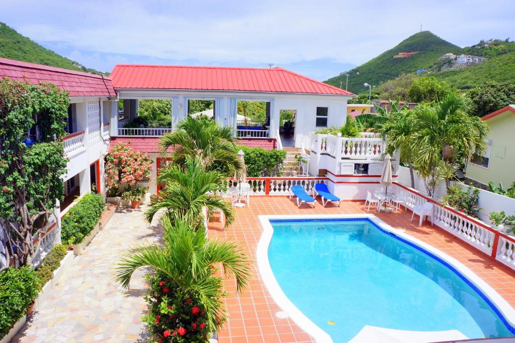 an aerial view of a house with a swimming pool at L'Esperance Hotel in Philipsburg